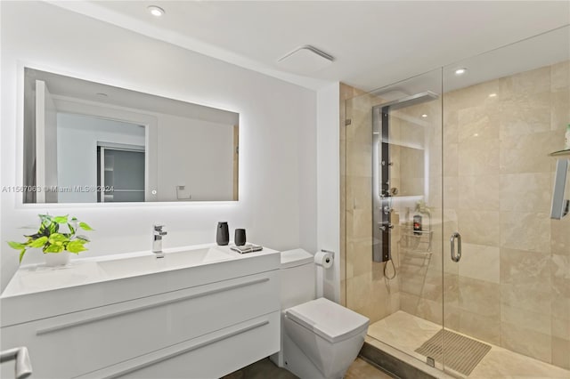 bathroom featuring vanity and a shower with shower door