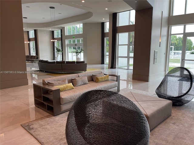 living room with a high ceiling and light tile floors