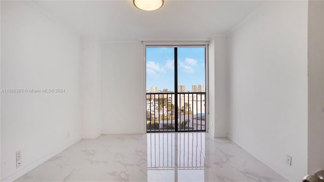 tiled spare room with ornamental molding