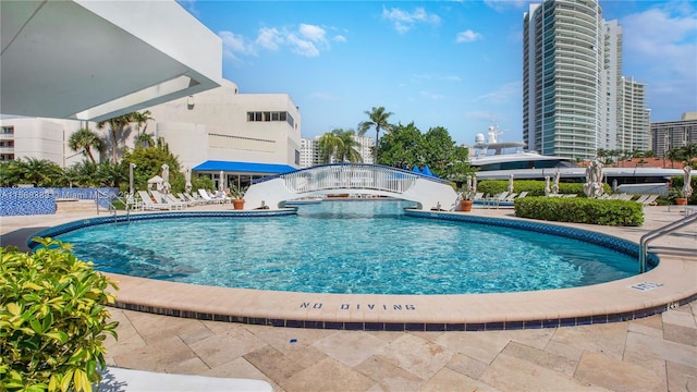 view of swimming pool featuring a hot tub