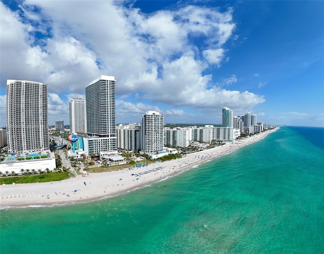 bird's eye view featuring a water view and a beach view