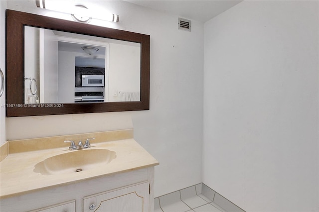 bathroom featuring tile patterned floors and vanity