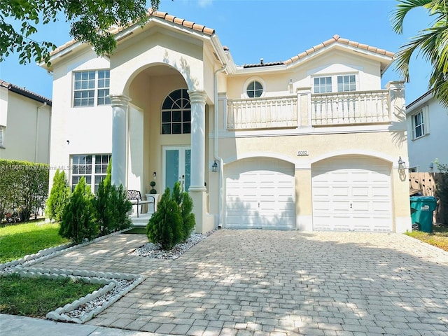 mediterranean / spanish-style house featuring a balcony and a garage