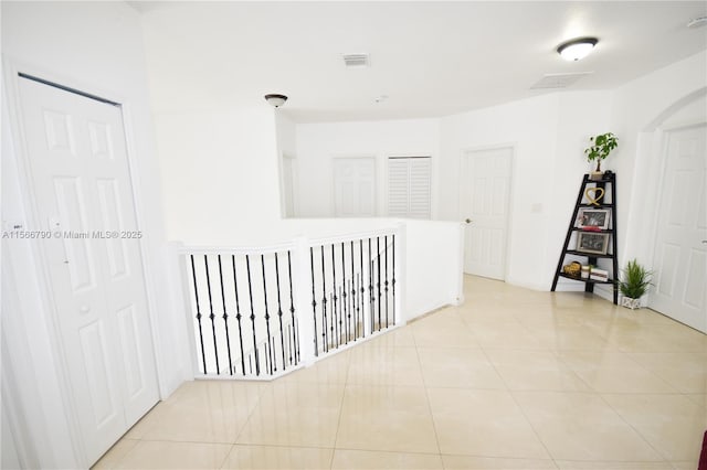 corridor with light tile patterned floors