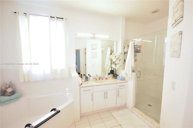 bathroom with vanity, a wealth of natural light, tile patterned floors, and plus walk in shower