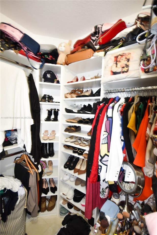 walk in closet featuring tile patterned flooring