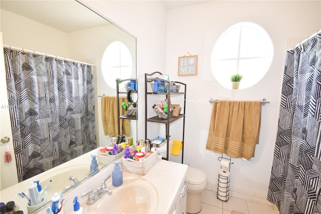 bathroom featuring vanity, toilet, and tile patterned flooring