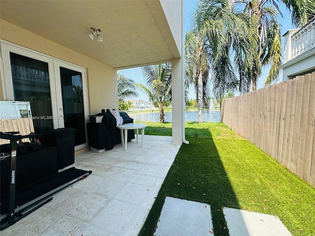 view of patio with a water view