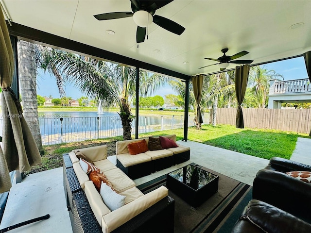 view of patio featuring a water view, ceiling fan, and outdoor lounge area