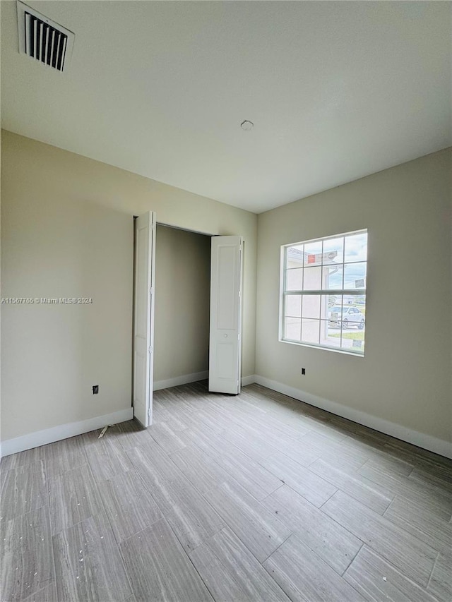 unfurnished bedroom with light hardwood / wood-style floors