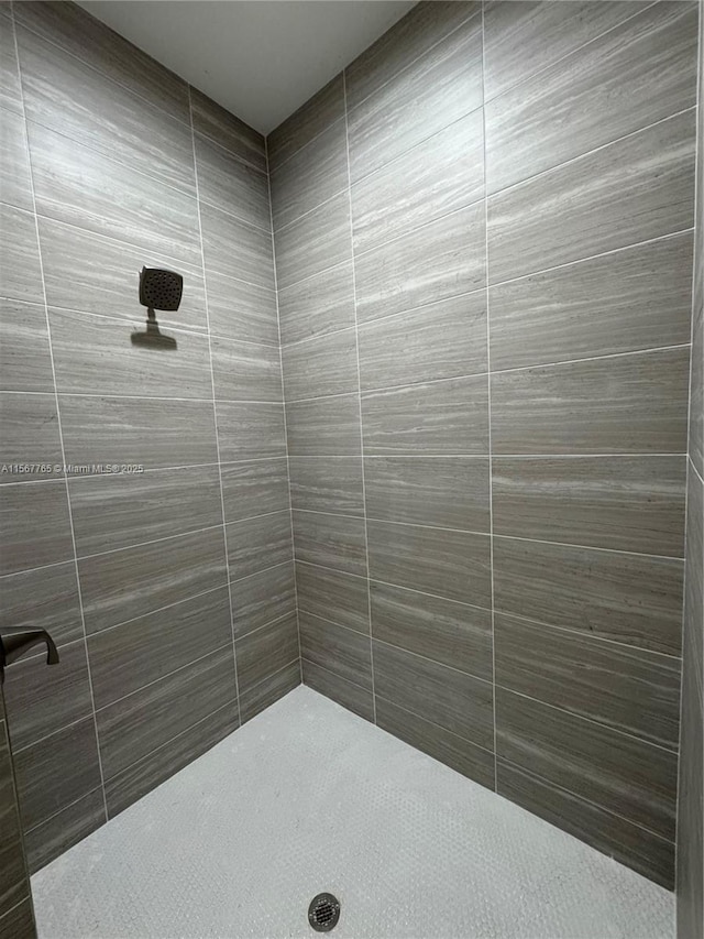 bathroom with a tile shower