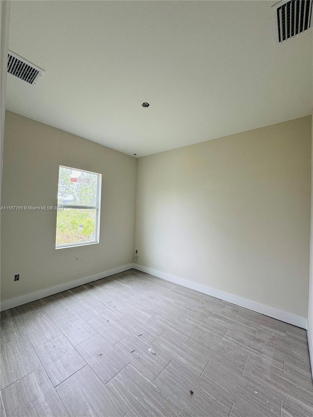 spare room with light hardwood / wood-style floors