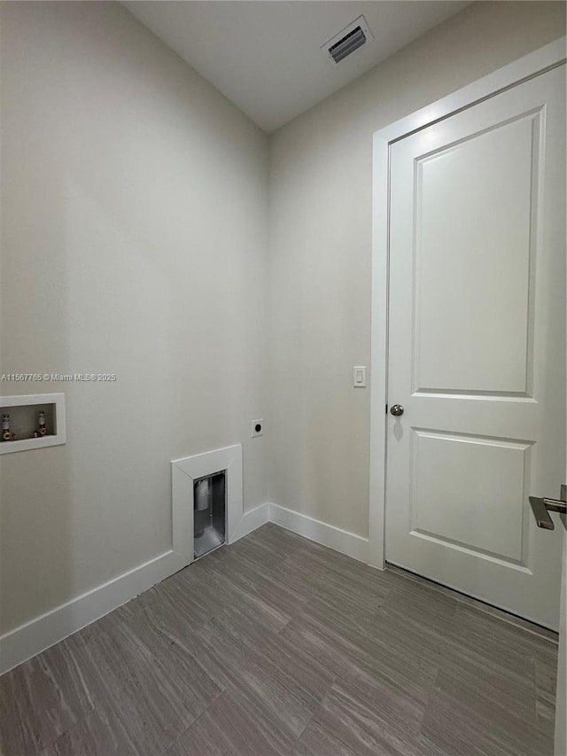 washroom with hardwood / wood-style floors, hookup for a washing machine, and hookup for an electric dryer