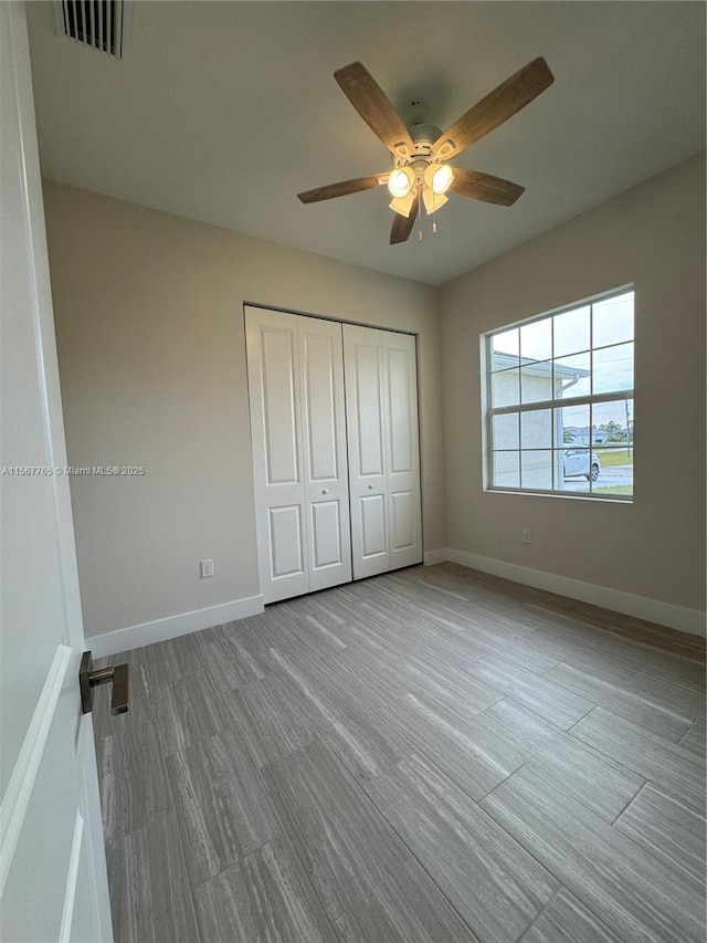 unfurnished bedroom with a closet and ceiling fan