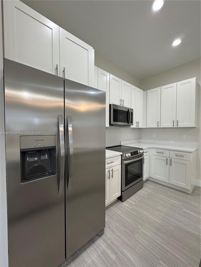 kitchen featuring white cabinetry and stainless steel appliances