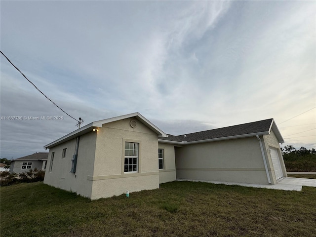 exterior space featuring a garage and a yard