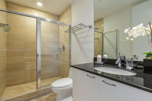 bathroom with oversized vanity, walk in shower, and toilet