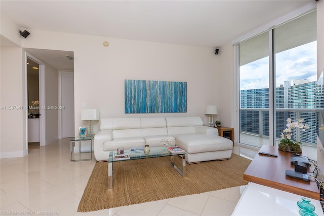 living room with a wall of windows and light tile flooring