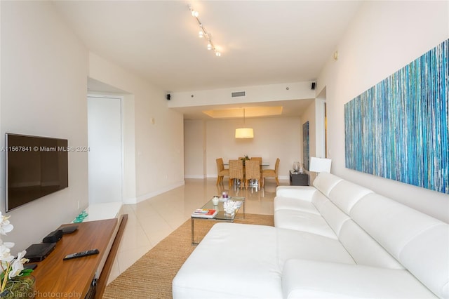 tiled living room with rail lighting