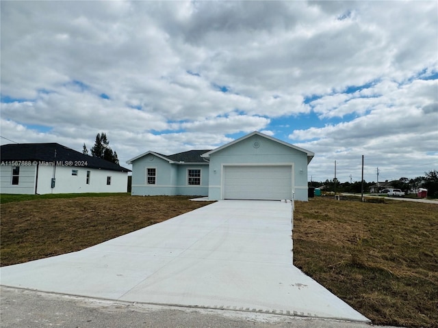 view of front of house with a front yard and a garage