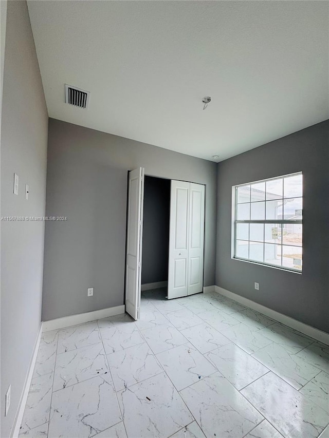 unfurnished bedroom featuring a closet