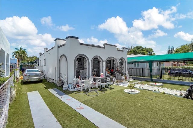 exterior space featuring a yard, fence, and stucco siding