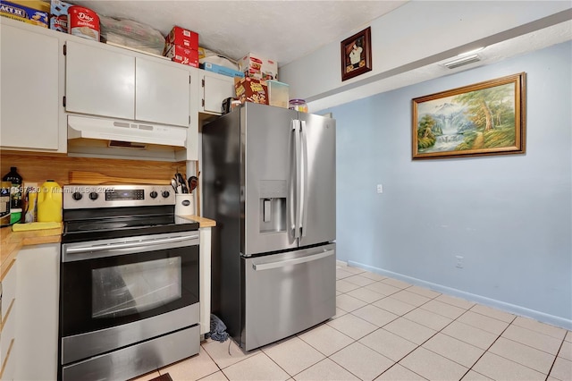 kitchen with light tile patterned floors, under cabinet range hood, visible vents, light countertops, and appliances with stainless steel finishes