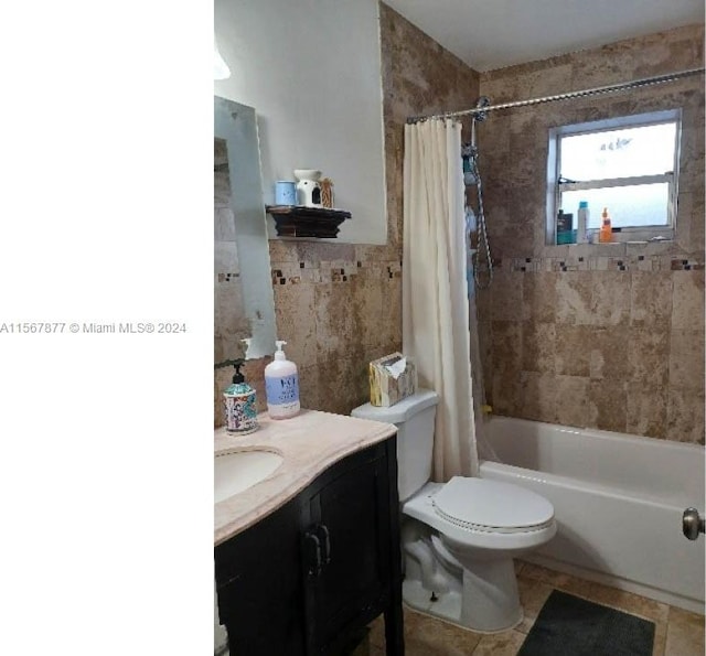 full bathroom with toilet, tile flooring, vanity, and shower / tub combo with curtain