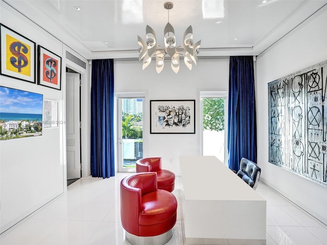 sitting room with a water view, light tile flooring, a chandelier, and a healthy amount of sunlight