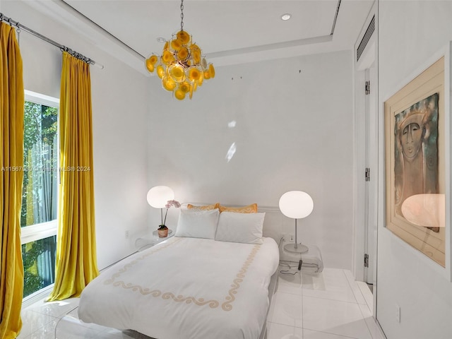 tiled bedroom featuring a chandelier