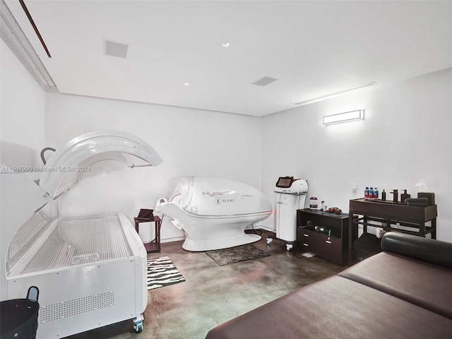 interior space with concrete flooring and toilet