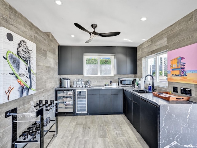 kitchen featuring tile walls, sink, ceiling fan, beverage cooler, and gray cabinetry