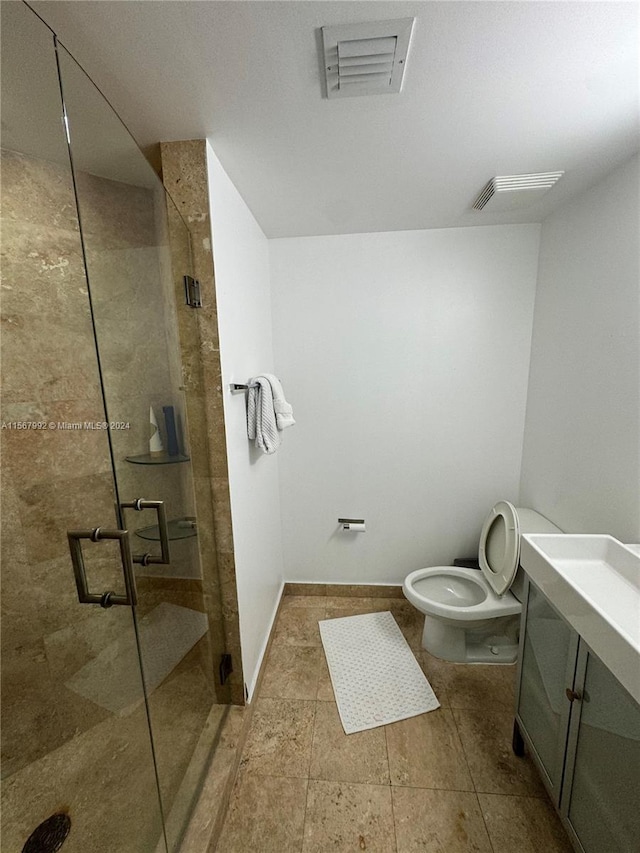 bathroom featuring tile flooring, toilet, an enclosed shower, and vanity