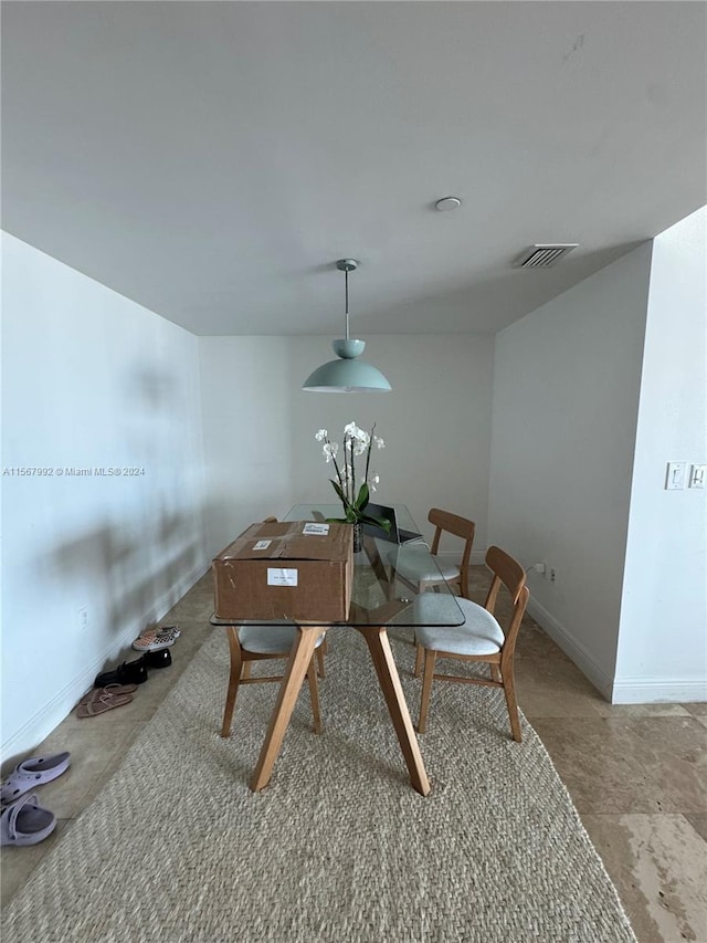 dining area featuring light tile floors