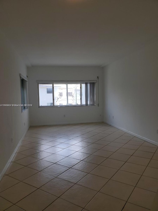 spare room with light tile floors