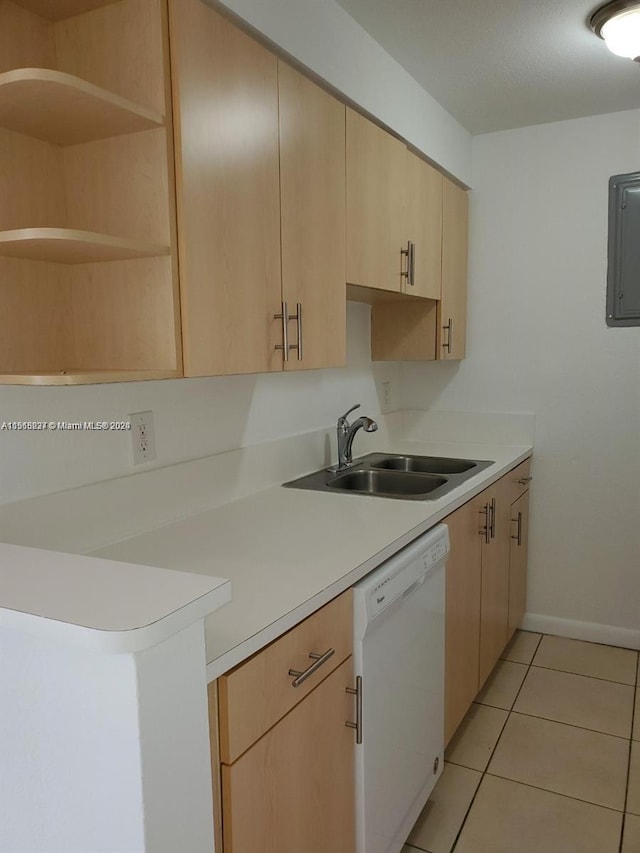 kitchen with sink, dishwasher, light tile floors, and light brown cabinets