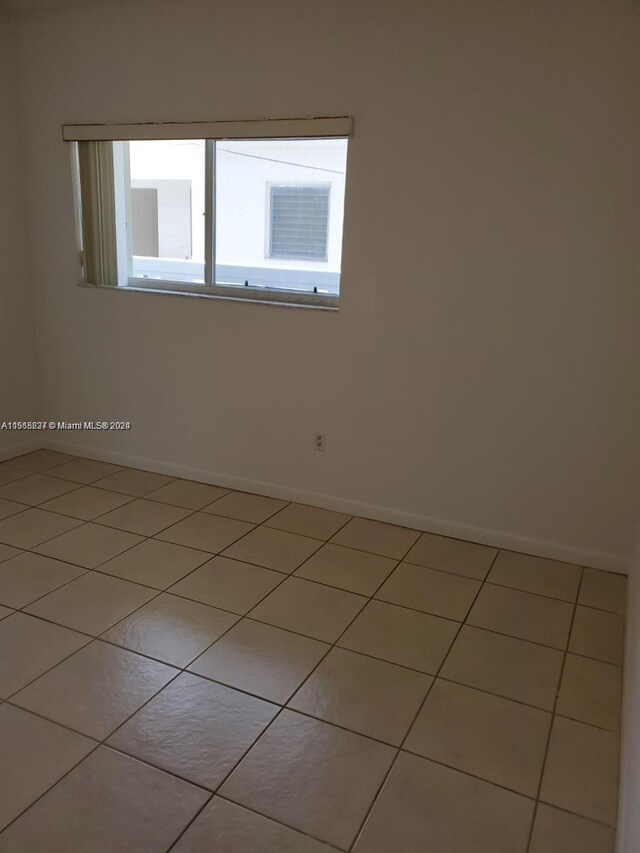 unfurnished room with tile flooring