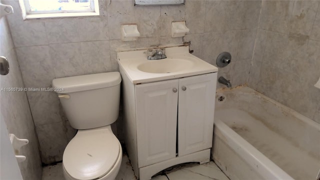 bathroom with vanity, toilet, and a washtub