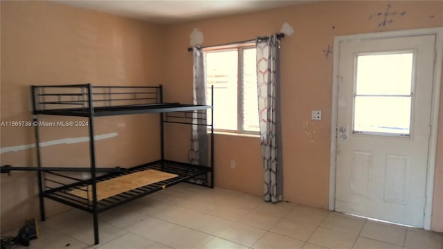 bedroom with light tile patterned flooring