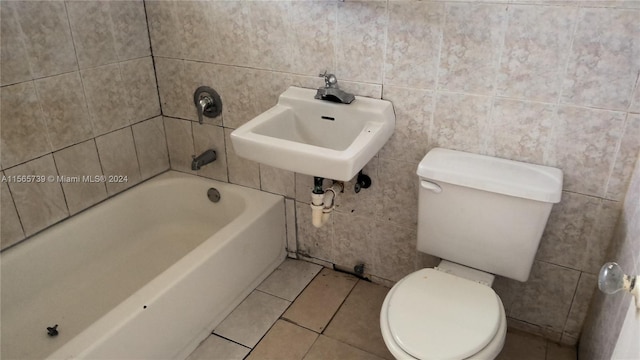 bathroom featuring tile walls, sink, tile patterned floors, and toilet