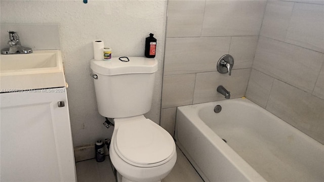 full bathroom featuring sink, tiled shower / bath combo, and toilet