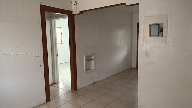 hallway with electric panel and light tile patterned floors