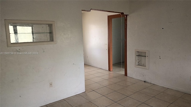 unfurnished room with light tile patterned floors