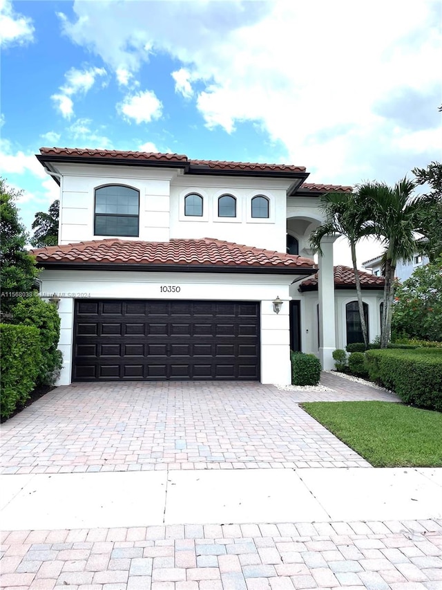 mediterranean / spanish-style house with a garage