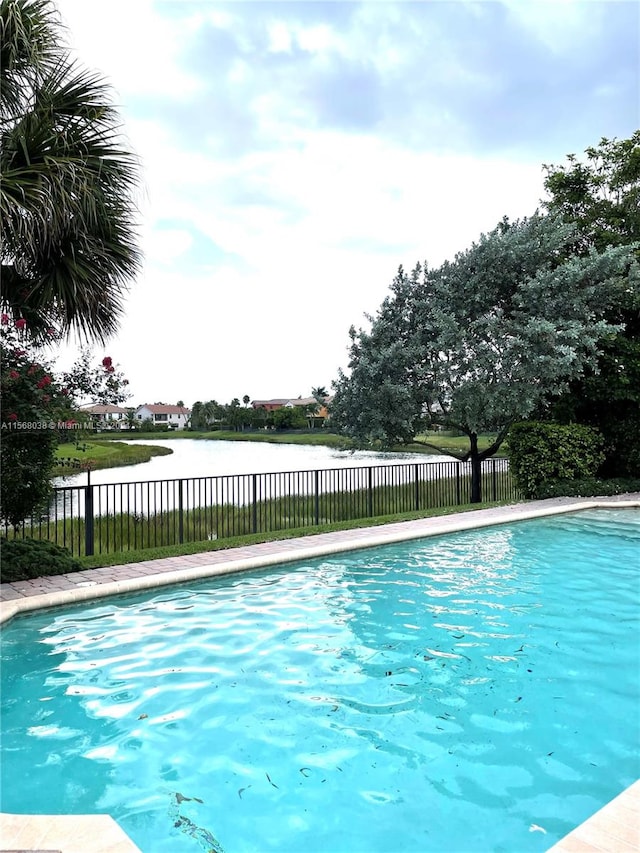 view of swimming pool with a water view