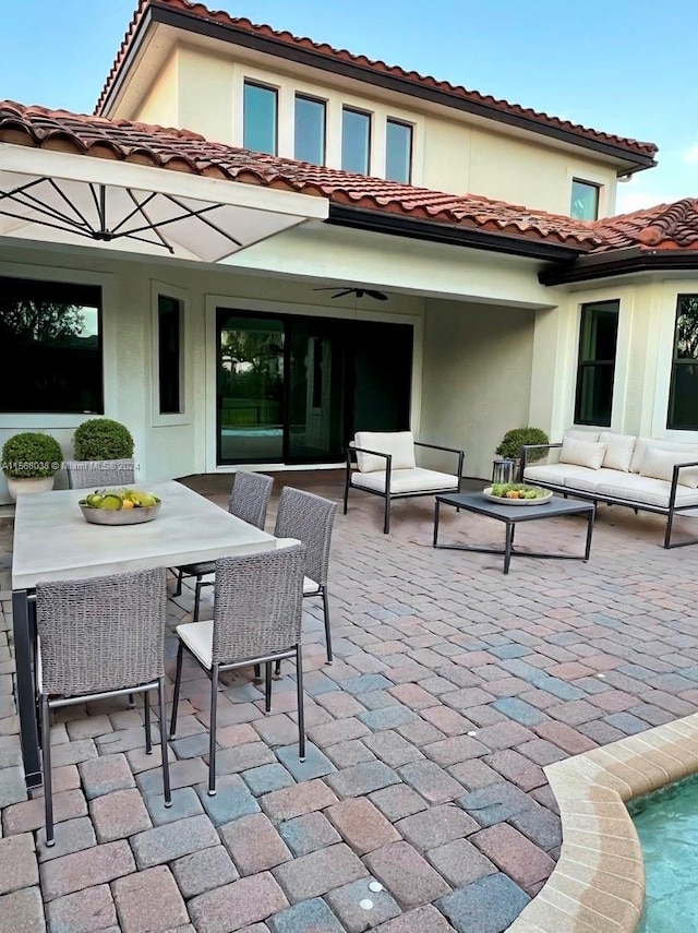 rear view of house with a patio area and an outdoor living space