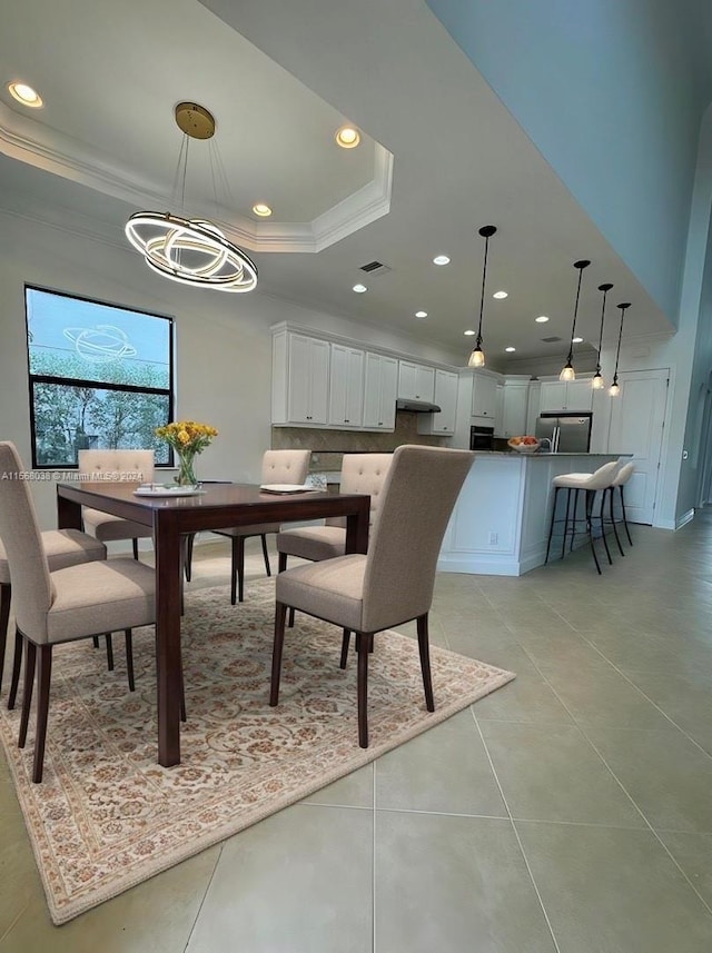 dining room featuring crown molding, an inviting chandelier, and light tile patterned floors