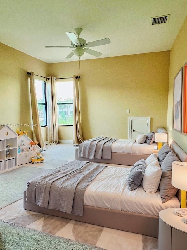 carpeted bedroom with ceiling fan