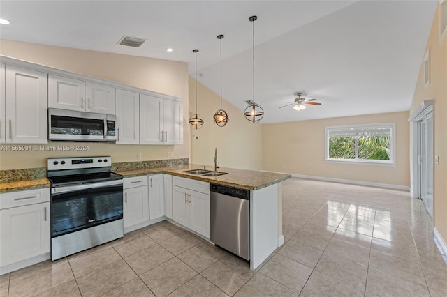 kitchen featuring sink, kitchen peninsula, lofted ceiling, white cabinets, and appliances with stainless steel finishes