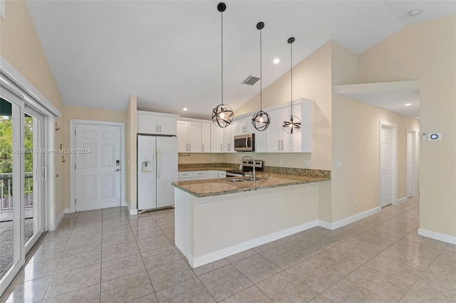 kitchen with sink, kitchen peninsula, white fridge with ice dispenser, decorative light fixtures, and white cabinetry